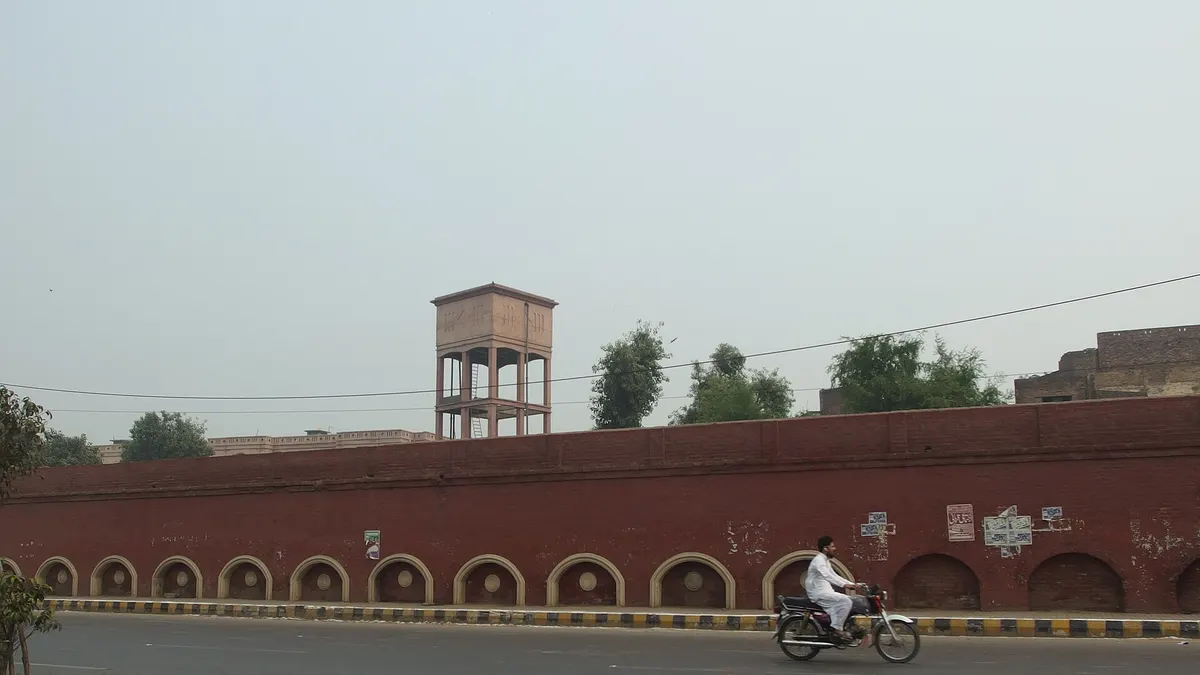 A man riding a motorcycle along a road in Lahore