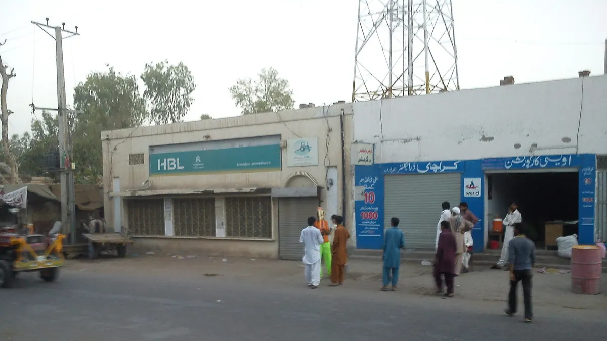 An HBL branch on a small-town street in Pakistan, with shoppers outside