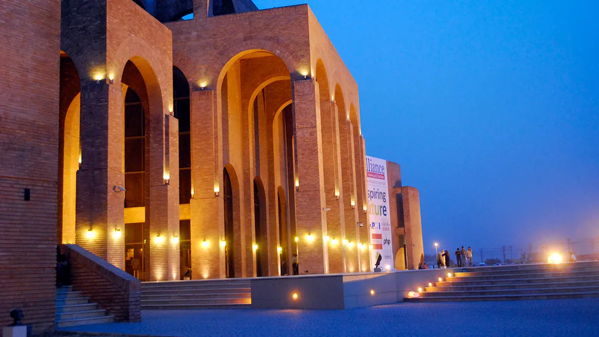 The brick arches of Expo Centre Lahore in Johar Town, lit up at dusk