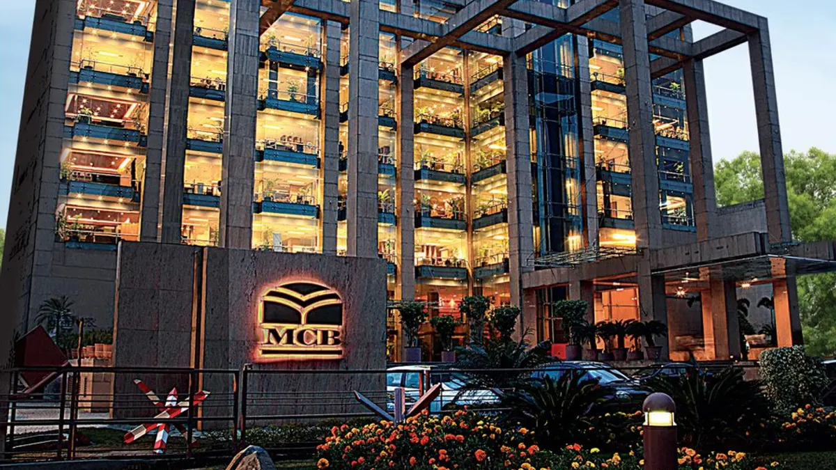MCB Bank's head office building, lit up at dusk