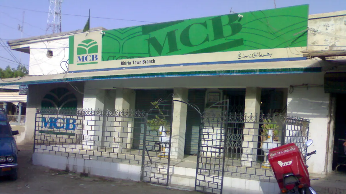 The MCB Bank branch in Bhiria Town, Sindh, with its green MCB sign and branch name in English and Urdu