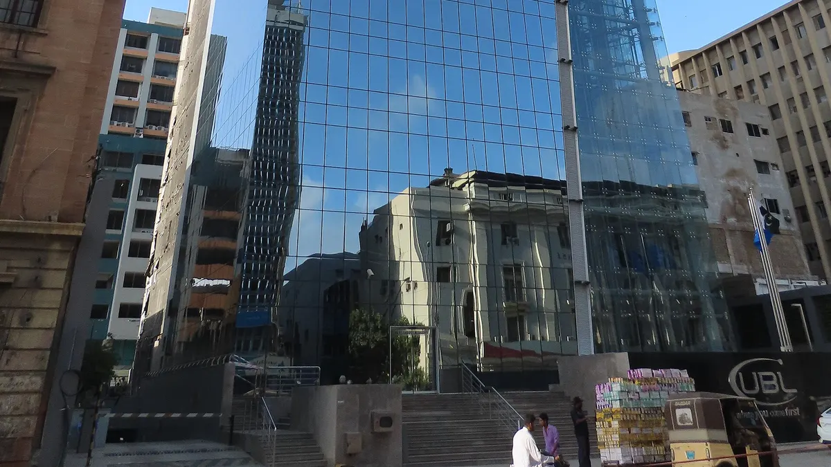 UBL's glass head-office tower on I.I. Chundrigar Road, Karachi, with the UBL sign at street level